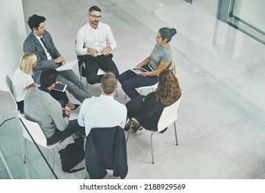 Support, care and unity by colleagues in a business meeting, sitting together in a modern office. Above a creative team brainstorming, planning and sharing an idea or goal while huddled in a circle - Shutterstock ID 2188929569