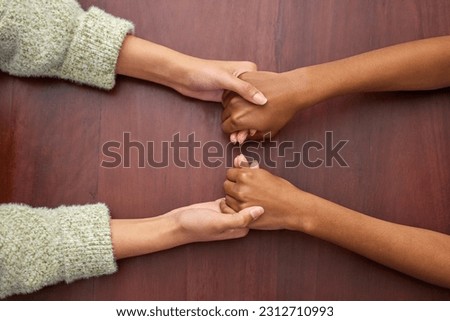 Support, empathy and people holding hands at school for trust, love and respect. Together, sorry and above of friends or students with a helping hand, forgiveness or compassion at a desk in college