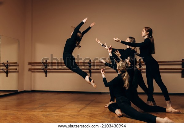 Support. A\
group of contemporary ballet dancers. Contemporary art. Young\
flexible athletic women ballet dancers. The concept of dance grace,\
inspiration, creativity. High quality\
photo