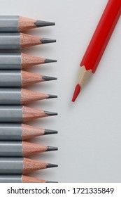 Support Group, Intervention. Conceptual. Red And Gray Pencils Opposite Each Other On An Isolated Background. Shallow Depth Of Field