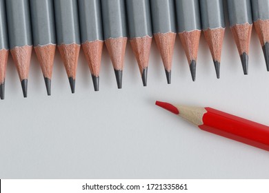 Support Group, Intervention. Conceptual. Red And Gray Pencils Opposite Each Other On An Isolated Background. Shallow Depth Of Field