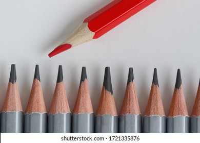 Support Group, Intervention. Conceptual. Red And Gray Pencils Opposite Each Other On An Isolated Background. Shallow Depth Of Field