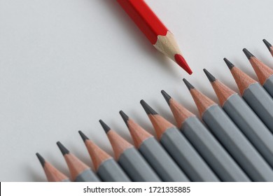 Support Group, Intervention. Conceptual. Red And Gray Pencils Opposite Each Other On An Isolated Background. Shallow Depth Of Field