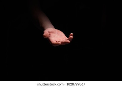 Support hand on a dark background. Helping hand from the dark