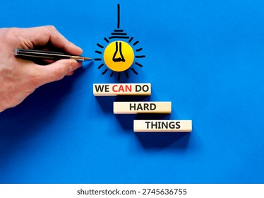 Support, help we can do hard things symbol. Concept words We can do hard things on beautiful wooden blocks. Beautiful blue background. Business we can do hard things concept. Copy space.