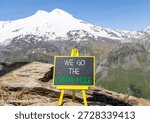Support, help we go the extra mile symbol. Concept words We go the extra mile on beautiful blackboard. Beautiful mountain Elbrus background. Business we go the extra mile concept. Copy space.