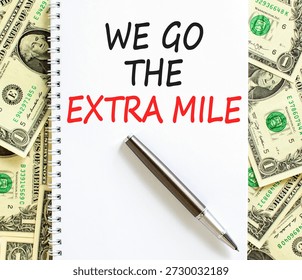 Support, help we go the extra mile symbol. Concept words We go the extra mile on beautiful white note. Beautiful dollar bills background. Business we go the extra mile concept. Copy space.