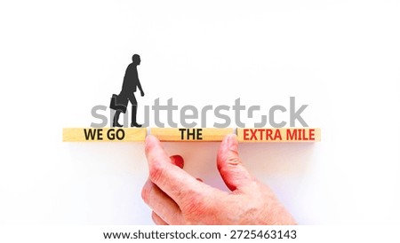 Support, help we go the extra mile symbol. Concept words We go the extra mile on beautiful wooden blocks. Beautiful white background. Business we go the extra mile concept. Copy space.