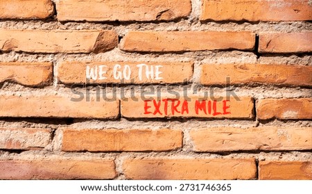 Support, help we go the extra mile symbol. Concept words We go the extra mile on beautiful brick wall. Beautiful brick wall background. Business we go the extra mile concept. Copy space.