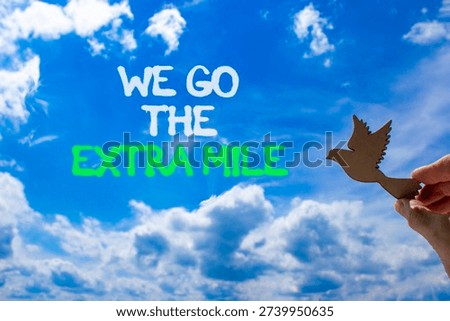 Support, help we go the extra mile symbol. Concept words We go the extra mile on beautiful sky. Beautiful blue sky background. Businessman's hand. Business we go the extra mile concept. Copy space.