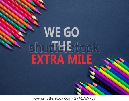 Support, help we go the extra mile symbol. Concept words We go the extra mile on beautiful grey paper. Beautiful grey background. Colored pencils. Business we go the extra mile concept. Copy space.