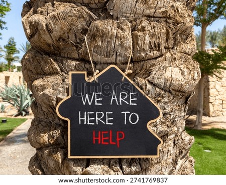 Support, help and we are here to help symbol. Concept words We are here to help on beautiful blackboard. Beautiful palm tree background. Business we are here to help concept. Copy space.