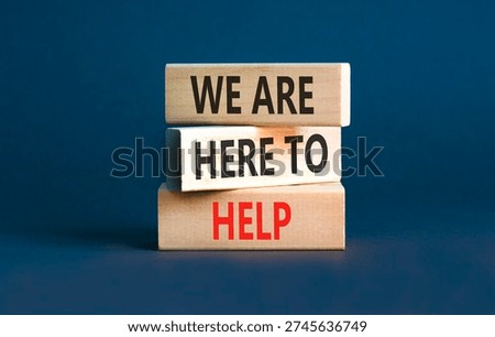 Support, help and we are here to help symbol. Concept words We are here to help on beautiful wooden blocks. Beautiful grey background. Business we are here to help concept. Copy space.