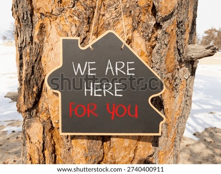 Support, help and we are here for you symbol. Concept words We are here for you on beautiful blackboard. Beautiful old tree background. Business we are here for you concept. Copy space.