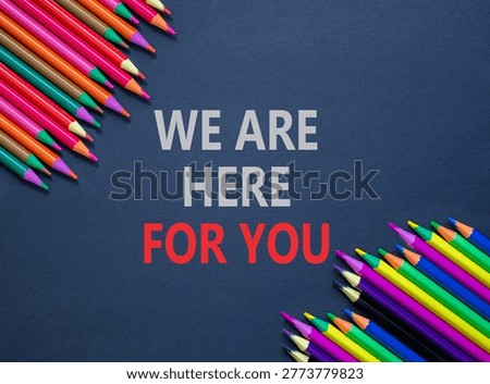 Support, help and we are here for you symbol. Concept words We are here for you on beautiful grey paper. Beautiful grey background. Colored pencils. Business we are here for you concept. Copy space.