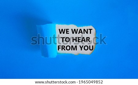 Support symbol. Concept words 'we want to hear from you' appearing behind torn blue paper. Beautiful blue background. Business and support concept.