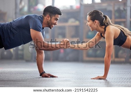 Support, teamwork and fitness couple doing workout training, challenging exercise for endurance, strength and stamina in a gym. Active, fit man and woman giving support and motivation during pushup