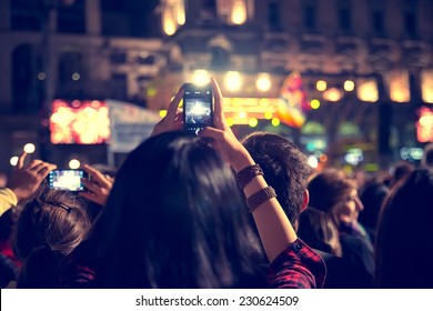 Supporters recording at concert - Candid image of crowd at rock concert