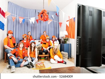 Supporters watching a game at home in front of the television - Powered by Shutterstock