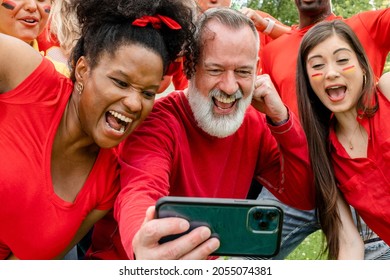 Supporters watching their team win the game on a mobile phone