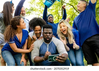 Supporters Watching Their Team Win The Game On A Mobile Phone