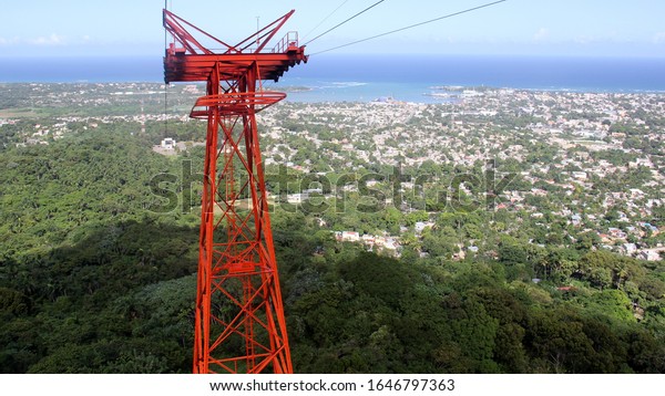 Supporting cable tower of the Cable Car, the town\
and the ocean below in the background, Puerto Plata, Dominican\
Republic - December 28,\
2013