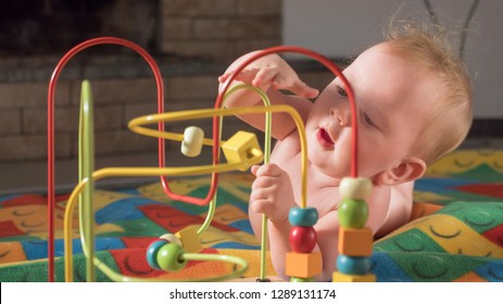 Supporting the development of fine motor skills. Fine motor skills developing. Gifts for toddlers, babies. Colorful toy appealing to hold. Montessori background. Toddler developing fine motor skills.
