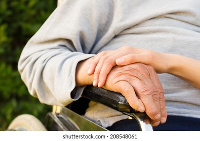 Supporting Hand Of A Family Member For Old And Disabled Grandfather.