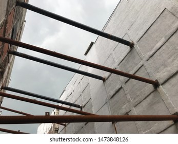 Supporting Metal Tubes Between Two Buildings, Construction Area Inbetween High Buildings In Urban Area.