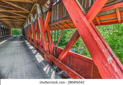 The supporting timber trusses are seen on the  interior of Indiana's historic Scipio Covered Bridge. - Powered by Shutterstock