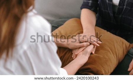 Supportive and comforting hands cheering up depressed patient person or stressed mind with prim empathy. Psychologist reassuring stressful and sad patient in clinic.