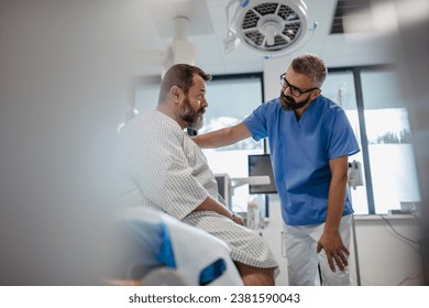 Supportive doctor soothing a worried overweight patient, discussing test result in emergency room. Illnesses and diseases in middle-aged men's health. Compassionate physician supporting stressed - Powered by Shutterstock