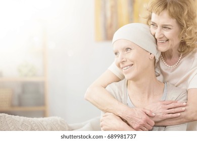 Supportive Older Woman Hugging Her Friend Struggling With Cancer