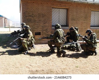 Suppressing enemy fire to save a comrade. Soldiers suppressing enemy fire while a comrade lies injured on the ground.