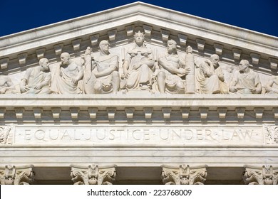 Supreme Court of the United States in Washington D,C. Blue sky behind. Ornate frieze on top of courtroom.