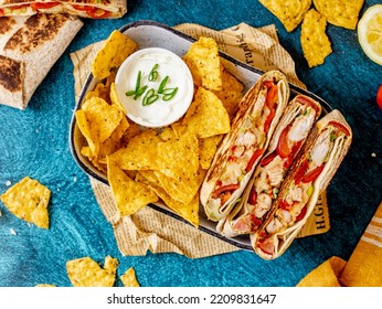 Supreme Nachos With Chicken Fajita, Corn Tortillas, And Sour Cream Dip On A Blue Background, Top View Horizontal Image, Tex Mex Dish