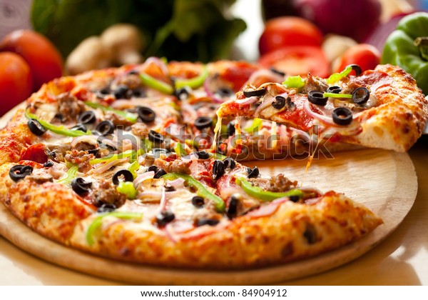 Supreme Pizza lifted slice\
1