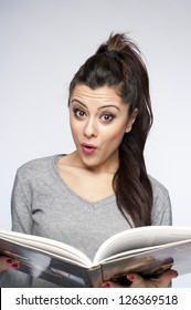Suprised Young Woman Reading Book