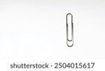 Surabaya, 17 August 2024. single paperclip in a vertical position, centered against a plain white background. 