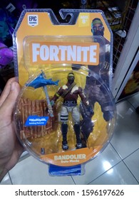 Surabaya, Indonesia - 18/12/2019 : Hand Hold A Bandoler Fortnite Character Toy Display For Sale At Toys Store