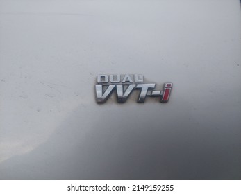 Surabaya, Indonesia - April 20, 2022 : "dual vvt-i" logo on the left front vender of a car.