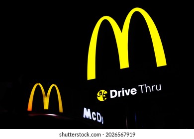 SURABAYA, INDONESIA – August 2021 : A Neon Sign Above A McDonalds Drive Thru In Surabaya.  