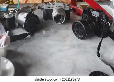 Surabaya, Indonesia - Circa 2018 : Group Of Fuji Film Camera On Marble Table.