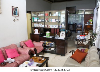 Surabaya, Indonesia - Dec 2010: View Of Old Living Room With Comfortable Coach And Wooden Cabinet Full With Photo Frame. No People.