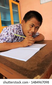 Surabaya - Indonesia. July 12, 2012. A Child With A Disability Is Learning To Write In Class. Surabaya City Social Service Provides Special Place For Neglected Children To Be Developed Through Educati