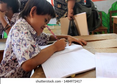 Surabaya - Indonesia. July 12, 2012. A Child With A Disability Is Learning To Write In Class. Surabaya City Social Service Provides Special Place For Abandoned And Disabled Children To Be Fostered Thr