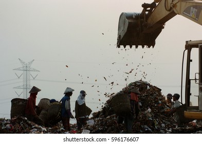 Surabaya, Indonesia - July 20, 2013: Silhouette find garbage in landfills Benowo, Surabaya, Indonesia.  - Shutterstock ID 596176607
