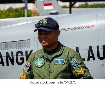 Surabaya, Indonesia - June 12, 2022: A Navy Pilot Poses In Front Of The Beechcraft Bonanza Plane On The Apron Of A Military Air Base