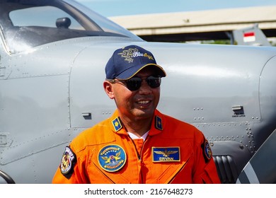 Surabaya, Indonesia - June 12, 2022: A Navy Pilot Poses In Front Of The Beechcraft Bonanza Plane On The Apron Of A Military Air Base