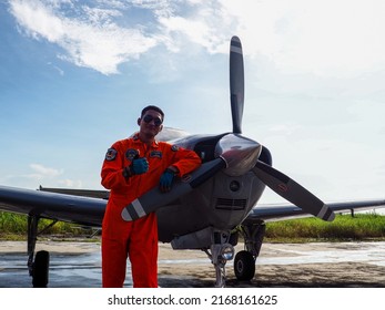 Surabaya, Indonesia - June 12, 2022: A Navy Pilot Poses In Front Of The Beechcraft Bonanza Plane On The Apron Of A Military Air Base